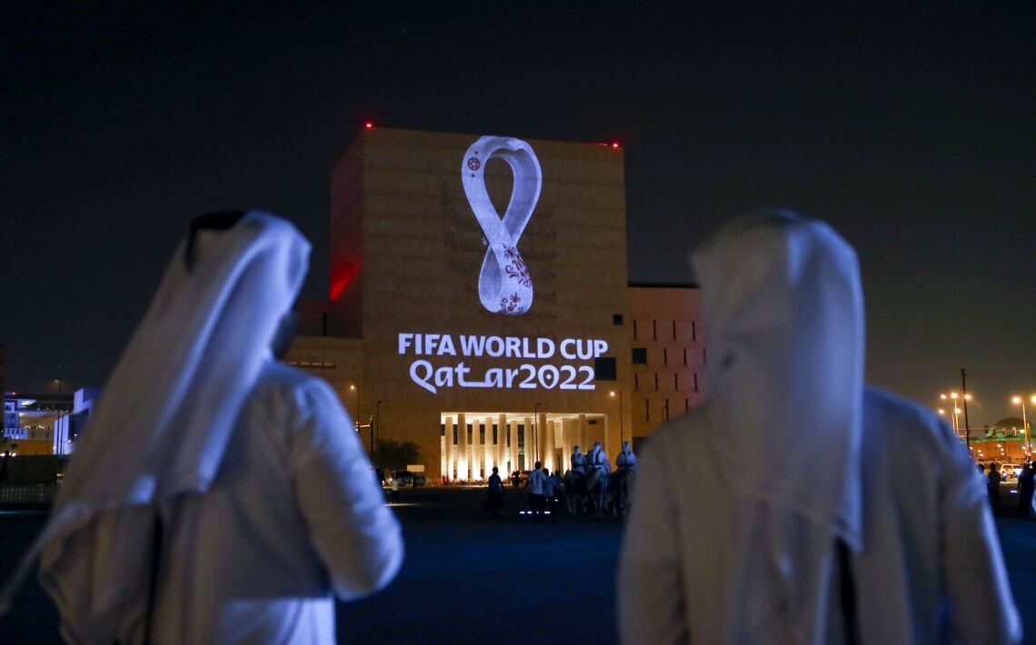 Qataris gather at the capital Doha's traditional Souq Waqif market as the official logo of the FIFA World Cup Qatar 2022 is projected on the front of a building on September 3, 2019.  / AFP / -